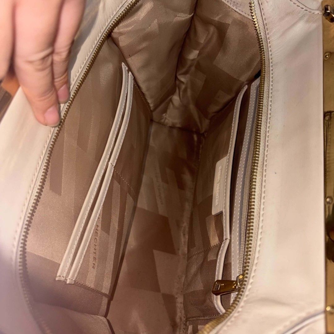 Daniel Hechter cream and grey leather handbag (Category: Luxury Bags & Wallets) located in Manila. Submitted by youresovaiineee (Listing ID 1470266292, Image 3). Description: - Brand: Daniel Hechter - Material: Cream and grey leather with gold-tone hardware - Design: Double top handles and front zip pocket - Interior: Geometric-patterned lining with multiple slip and zip compartments - Condition: Noticeable scuffs and peeling on the bottom base l