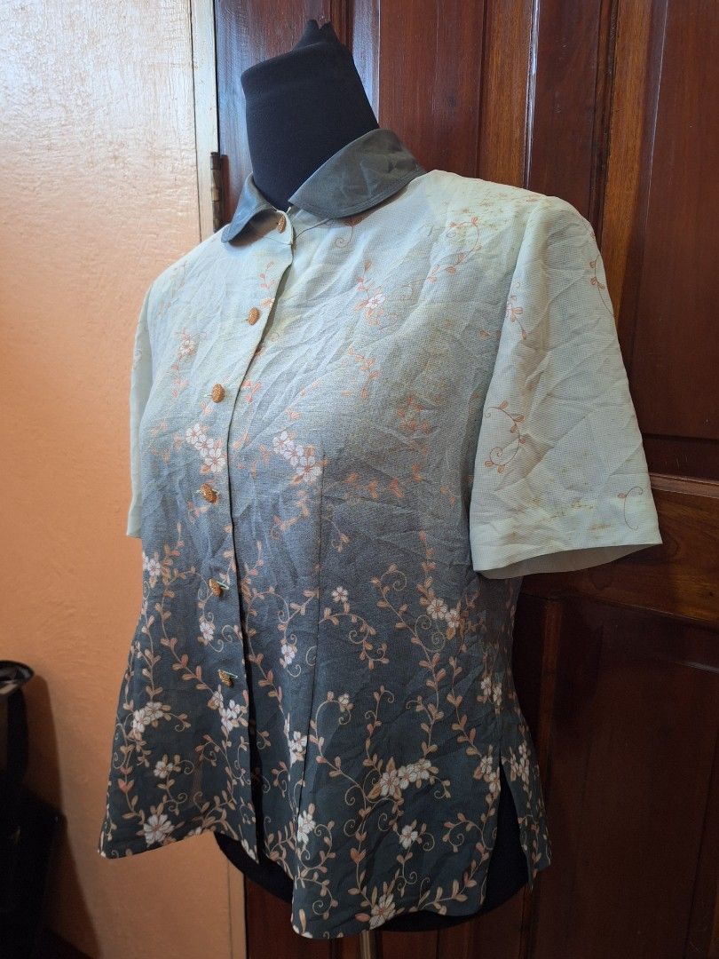 Dante Floral Short Sleeve Button-Up Blouse (Category: Blouses) located in Balamban. Submitted by ubethan (Listing ID 1470212332, Image 3). Description: - Brand: Dante - Style: Short sleeve button-down blouse with collared neckline and decorative round buttons - Design: Green and dark grey ombre effect with all-over white floral vine print - Fabric: Lightweight and comfortable - Condition: Brand new with tag intact.