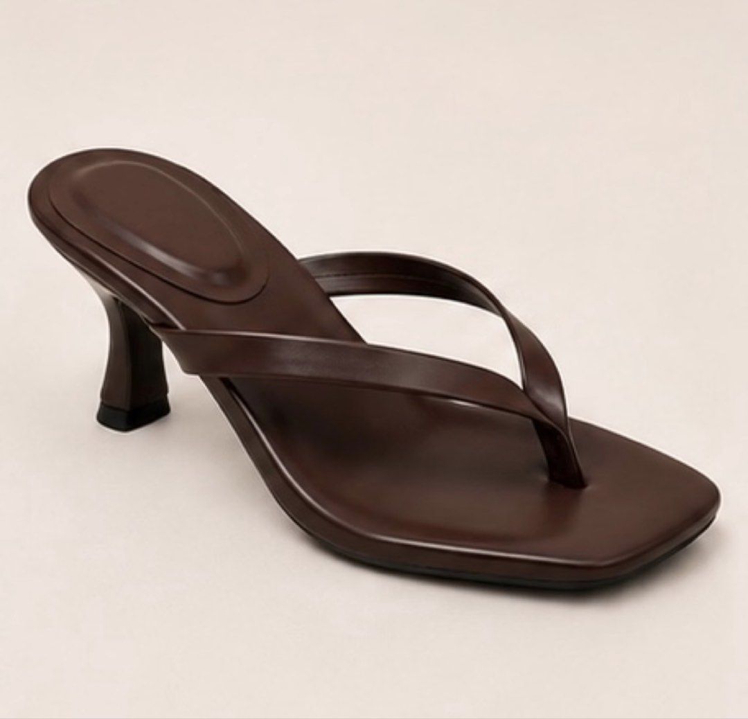 Dark Brown Square Toe Thong Kitten Heel Mules (Category: Heels) located in Mandaluyong City. Submitted by modeblogg (Listing ID 1470183379, Image 1). Description: - Color: Dark brown - Design: Thong style with modern square toe - Heel: Comfortable kitten heel for daily wear - Versatility: Easy slip-on design, perfect for skirts, jeans, and casual outfits - Condition: Brand new (unused) / Ready to ship RFS: Wrong size.