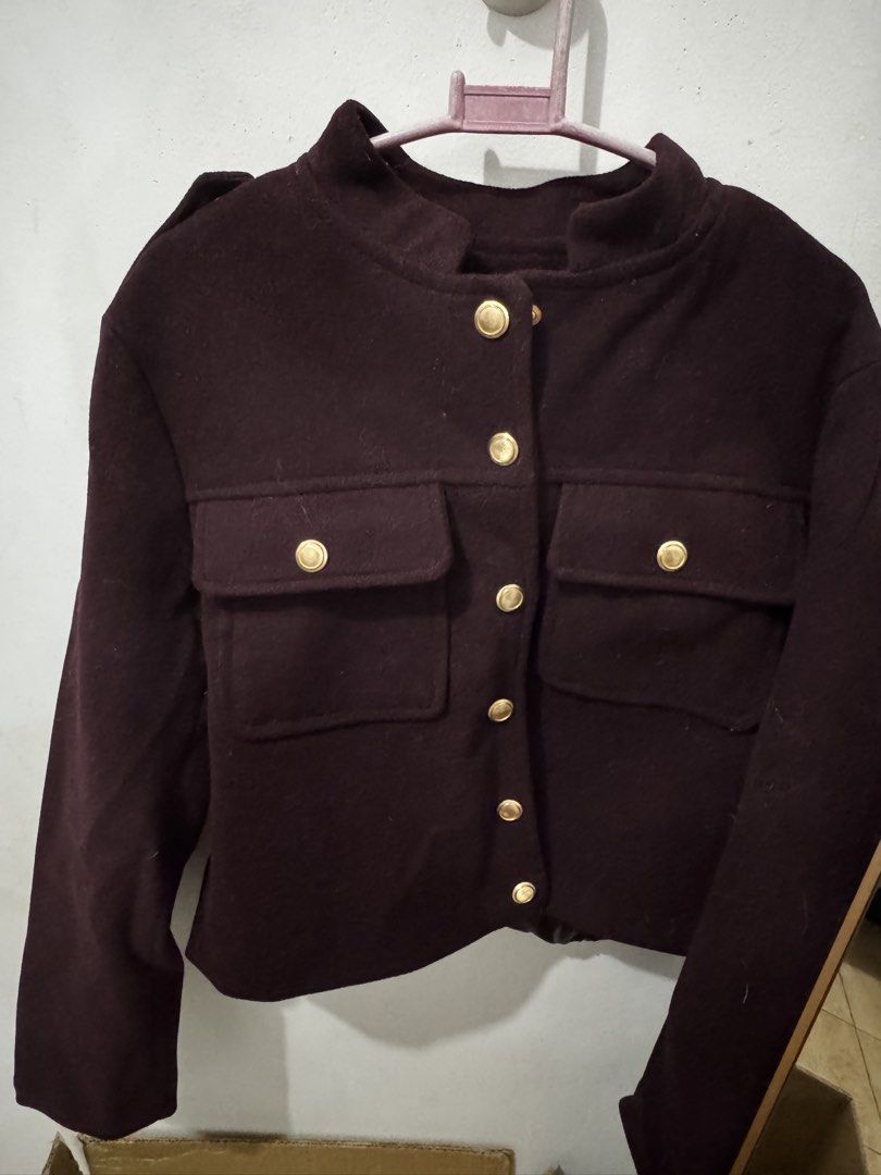 Dark brown wool jacket with gold buttons (Category: Coats, Jackets and Outerwear) located in Marikina City. Submitted by potchayy (Listing ID 1470263961, Image 1). Description: - Color: Dark brown - Material: Heavy winter wool fabric - Design: Stand-up collar with structured shoulders - Closure & Pockets: Brass-tone metal buttons down the front and on both chest pockets - Fit: Short, waist-level length - Condition: Excellent.
