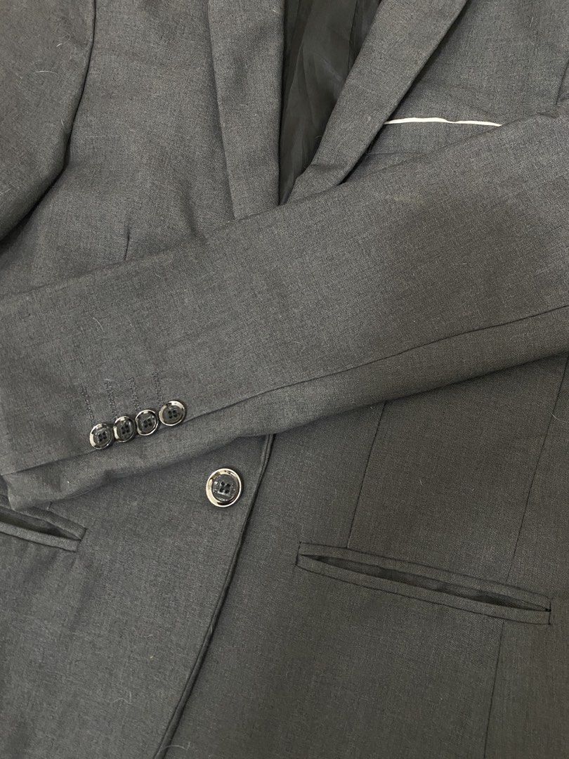 Dark Grey Single Button Blazer Jacket (Category: Coats, Jackets and Outerwear) located in Pasig City. Submitted by crybbeee (Listing ID 1470279576, Image 2). Description: - Brand: Chorbmark - Size: on tag Small, Large on me - Color: Dark Grey - Closure: Single front button - Pockets: Front welt pockets and chest pocket square detail - Cuffs: Four decorative buttons - Lining: Fully lined interior with Shoulder pads - Condition: Excellent, ready to