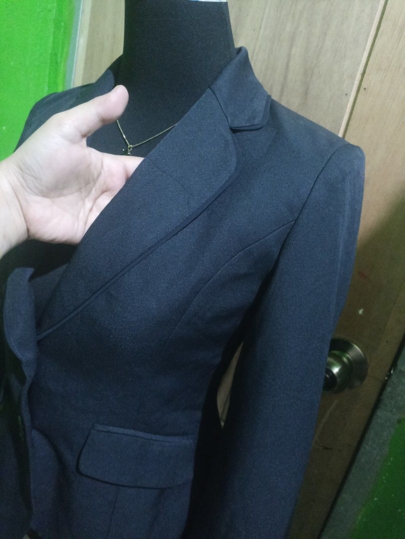 Dark Navy Blue Fitted Formal Blazer (Category: Coats, Jackets and Outerwear) located in Tarlac. Submitted by allinoneshop2178 (Listing ID 1470252833, Image 2). Description: - Color: Dark navy blue - Silhouette: Structured with a fitted waist - Closure: Two black front buttons - Pockets: Flap pockets on both sides - Details: Clean lapel collar, long sleeves with slit cuffs - Fabric: Smooth inside and out - Ideal for: Workwear, interviews, and form