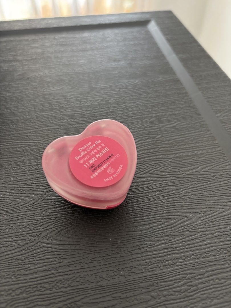 Dasique Souffle Color Pot 11 Cherry Custard (Category: Makeup) located in Binan City. Submitted by laurenarriane_owl (Listing ID 1470143056, Image 2). Description: - Brand: Dasique - Product: Souffle Color Pot - Shade: 11 Cherry Custard - Packaging: Heart-shaped compact with pink lid and clear base - Condition: Gently swatched in the center - Inclusion: Small applicator brush included inside the case - Origin: Made in Korea - Expiry Date: Novembe