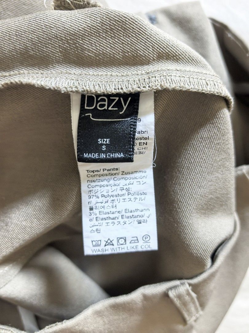 Dazy Beige High-Waisted Wide-Leg Pants (Category: Other Bottoms) located in Tacloban City. Submitted by thead.declutters (Listing ID 1470209038, Image 3). Description: - Brand: Dazy - Size: S - Color: Neutral beige - Fit: High-waisted wide-leg - Details: Front pleats, side pockets, clean back design with belt loops - Material: Lightweight polyester and elastane blend with a bit of stretch - Styling: Versatile for casual outings or office wear.