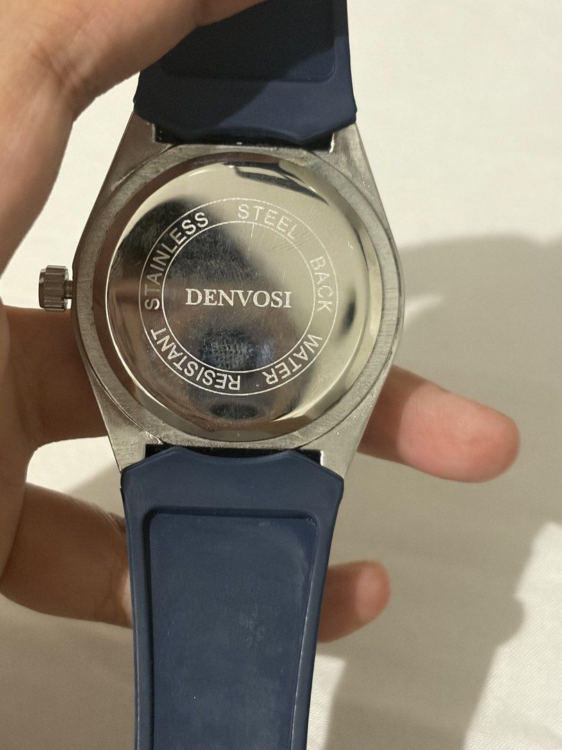 Denvosi Quartz Watch Blue Dial Rubber Strap (Category: Men's Watches) located in Quezon City. Submitted by clareb (Listing ID 1470286270, Image 3). Description: - Brand: Denvosi - Movement: Reliable Quartz - Dial: Textured blue with date window at 3 o'clock - Case: Silver-tone with stainless steel back - Strap: Dark blue patterned rubber with pin buckle - Condition: Great daily driver / stylish accessory.