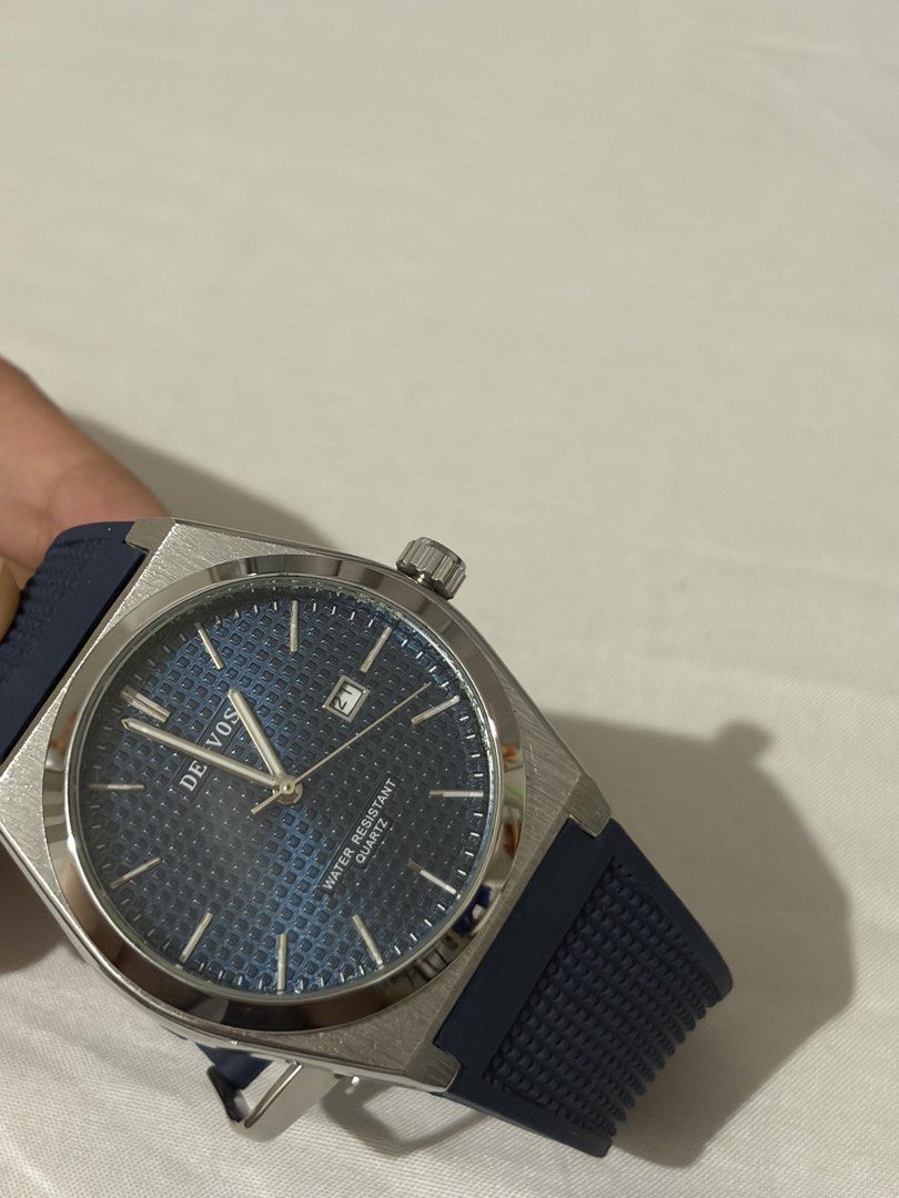 Denvosi Quartz Watch Blue Dial Rubber Strap (Category: Men's Watches) located in Quezon City. Submitted by clareb (Listing ID 1470286270, Image 2). Description: - Brand: Denvosi - Movement: Reliable Quartz - Dial: Textured blue with date window at 3 o'clock - Case: Silver-tone with stainless steel back - Strap: Dark blue patterned rubber with pin buckle - Condition: Great daily driver / stylish accessory.