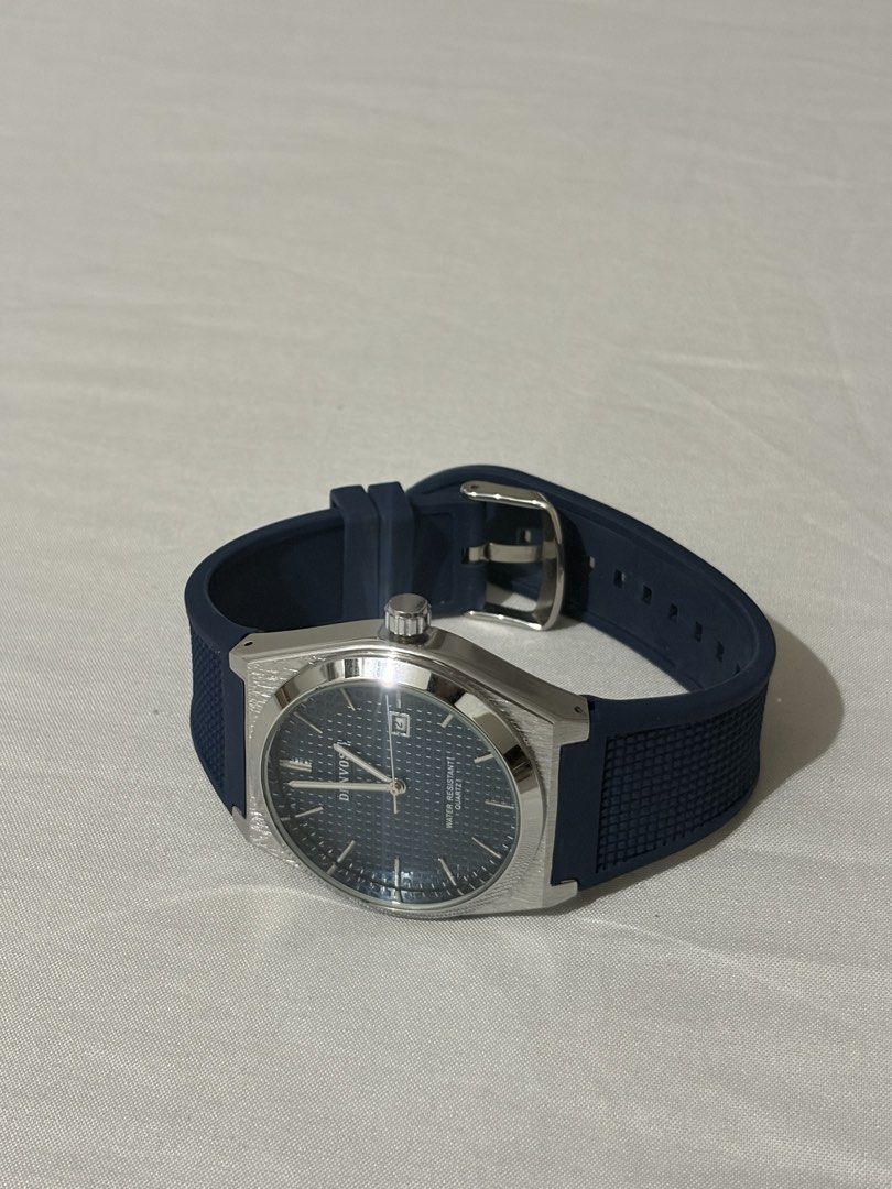 Denvosi Quartz Watch Blue Dial Rubber Strap (Category: Men's Watches) located in Quezon City. Submitted by clareb (Listing ID 1470286270, Image 1). Description: - Brand: Denvosi - Movement: Reliable Quartz - Dial: Textured blue with date window at 3 o'clock - Case: Silver-tone with stainless steel back - Strap: Dark blue patterned rubber with pin buckle - Condition: Great daily driver / stylish accessory.