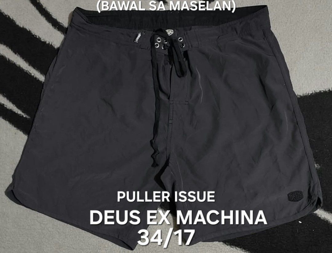 Deus Ex Machina Board Shorts Size 34 (Category: Swim Trunks & Board Shorts) located in San Fernando, Camarines Sur. Submitted by ladderaya (Listing ID 1470242951, Image 1). Description: - Brand: Deus Ex Machina - Color: Dark Grey - Size: 34 - Material: Lightweight fabric ideal for surfing and beach days - Features: Secure zip pocket on the back with branded hardware and adjustable drawstring waist with metallic eyelets - Condition note: Minor pul