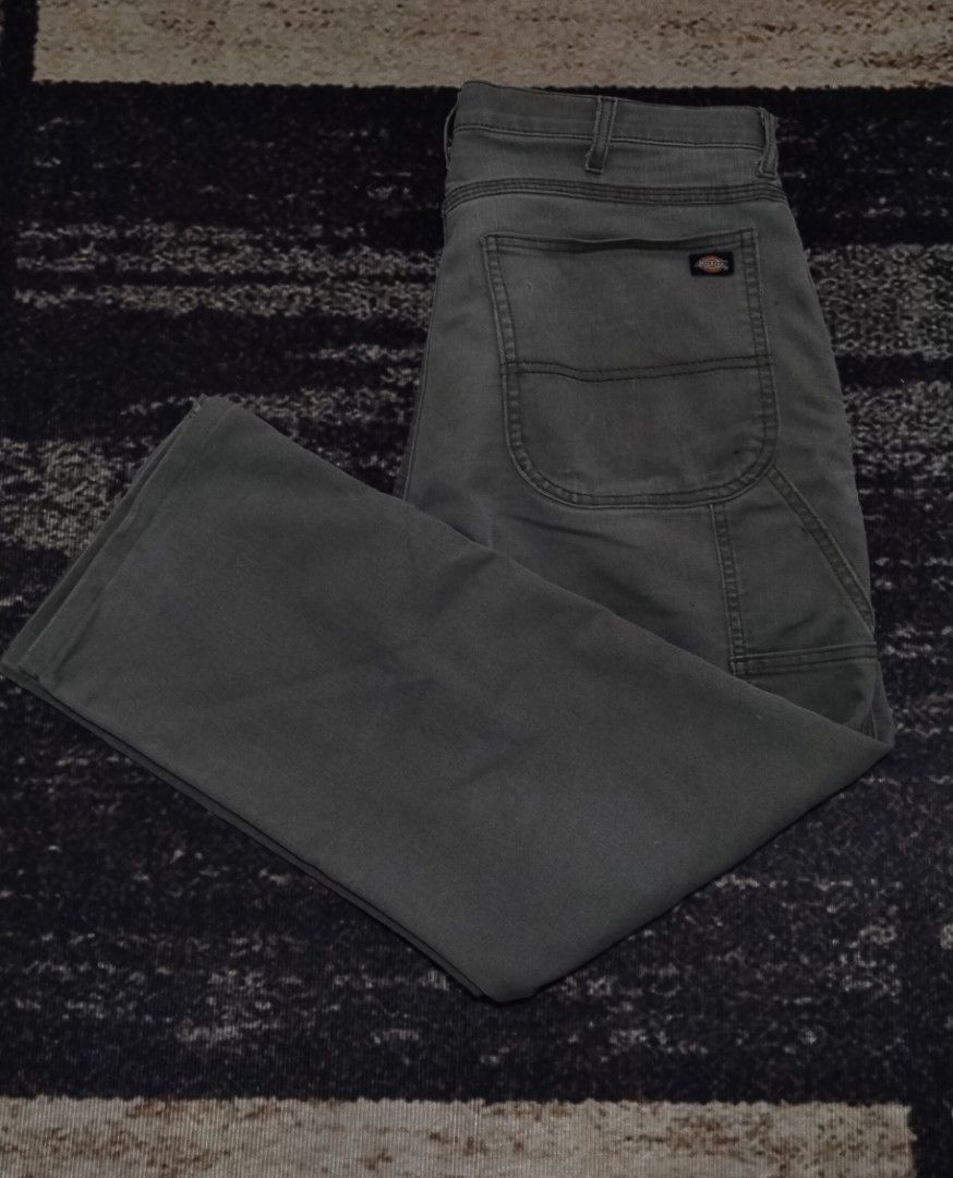 Dickies Green Carpenter Pants (Category: Jeans) located in Manila. Submitted by ianmontede19006 (Listing ID 1470173543, Image 1). Description: - Brand/Model: Dickies Carpenter Pants - Color: Olive Green - Material: Thick, sturdy cotton fabric - Features: Side utility pockets and left hammer loop - Condition: Shows normal wear with a small tear on the right back pocket - Style: Classic workwear.