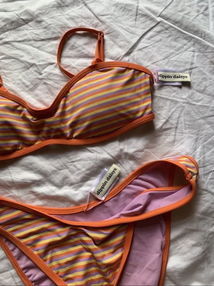 Dippin’ Daisy’s Stripe Bikini Set (Category: Bikinis & Swimsuits) located in Taguig. Submitted by prelovedbynette (Listing ID 1470317226, Image 3). Description: For size, pls refer to the size chart from the brand’s official website (see last photo) Top is size S with adjustable straps Bottom is size M With minimal stain at the back of the top (see 7th photo) Set retails for 6-7k Helping tags: Blackbough, H&M, Eight Mermaid.