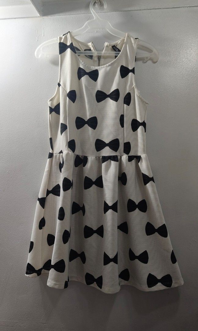 Divided by H&M Bow Print Dress Size M (Category: Dresses) located in Makati City. Submitted by beedg (Listing ID 1470323213, Image 2). Description: - Brand: Divided by H&M - Style: Sleeveless dress with all-over black bow pattern - Color: Off-white - Material: Textured ribbed fabric - Closure: Metal zipper down the back - Size: M - Made in: Turkey - Note: Measurements available upon request.