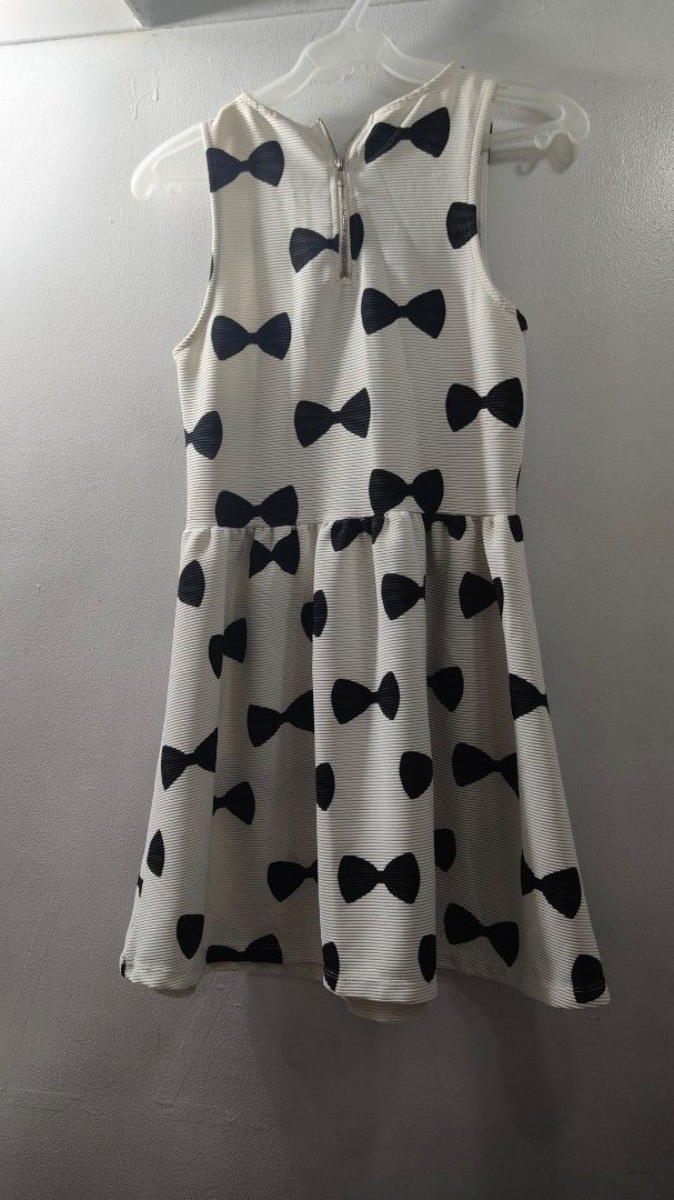 Divided by H&M Bow Print Dress Size M (Category: Dresses) located in Makati City. Submitted by beedg (Listing ID 1470323213, Image 1). Description: - Brand: Divided by H&M - Style: Sleeveless dress with all-over black bow pattern - Color: Off-white - Material: Textured ribbed fabric - Closure: Metal zipper down the back - Size: M - Made in: Turkey - Note: Measurements available upon request.
