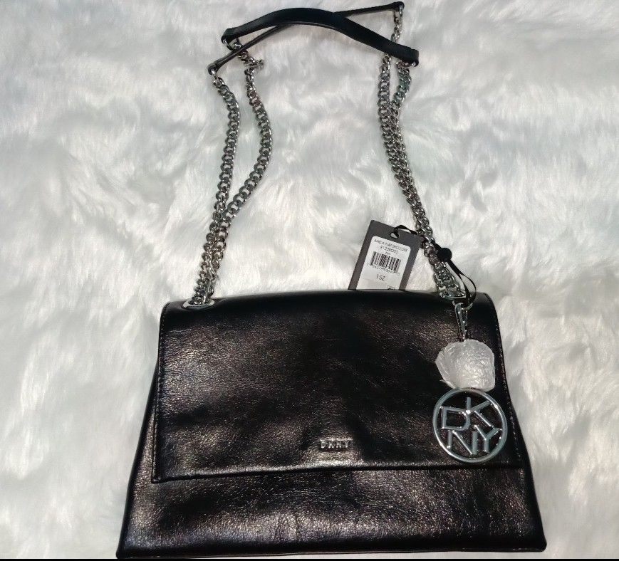 DKNY Amelia Flap Shoulder Bag Black Chain Strap (Category: Luxury Bags & Wallets) located in Rosales. Submitted by lynasonlineshop (Listing ID 1470165497, Image 3). Description: - Brand: DKNY (Amelia Flap Shoulder Bag) - Color: Classic Black Leather - Hardware: Silver-tone chain strap & matching DKNY logo charm - Interior: Zip pocket with signature branded lining - Condition: Brand new with retail tags attached - Inclusions: Original dust bag inc