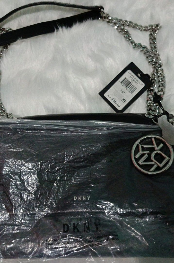 DKNY Amelia Flap Shoulder Bag Black Chain Strap (Category: Luxury Bags & Wallets) located in Rosales. Submitted by lynasonlineshop (Listing ID 1470165497, Image 2). Description: - Brand: DKNY (Amelia Flap Shoulder Bag) - Color: Classic Black Leather - Hardware: Silver-tone chain strap & matching DKNY logo charm - Interior: Zip pocket with signature branded lining - Condition: Brand new with retail tags attached - Inclusions: Original dust bag inc