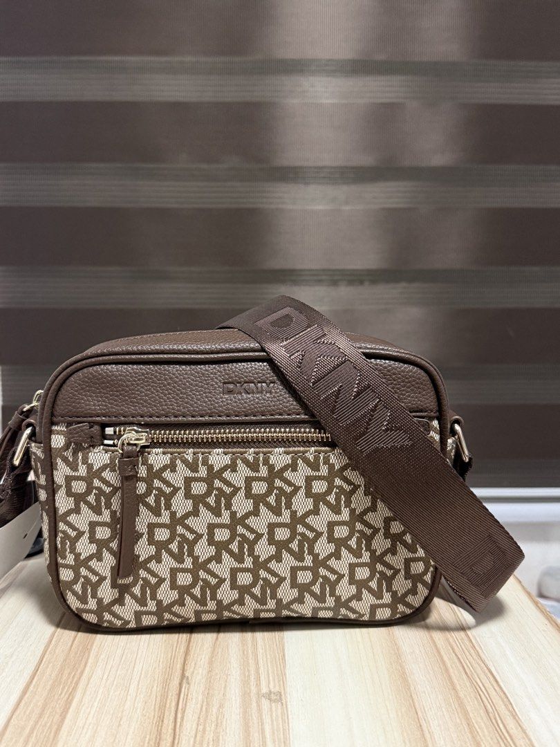 DKNY Brown Monogram Crossbody Bag (Category: Cross-body Bags) located in Mandaluyong City. Submitted by shoppingmilesph (Listing ID 1470286631, Image 1). Description: 🤎 Original & brand new DKNY 💯 🤎Color/Pattern: Brown with DKNY monogram 🤎 Material: Pebbled leather accents and durable fabric 🤎Compartments: Secure zipper closure and back zipper pocket 🤎 Strap: Thick, adjustable webbed strap with DKNY logo .