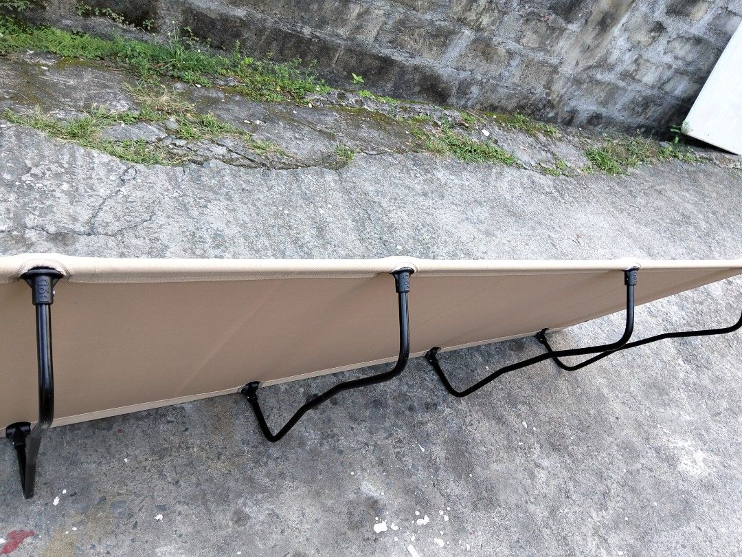 DOD Camping Cot Tan Color Portable Bed (Category: Hiking & Camping) located in Abucay. Submitted by cristineca20489 (Listing ID 1470334100, Image 3). Description: - Brand: DOD Camping Cot - Color: Stylish Tan - Weight: Lightweight at only 2.6kg - Capacity: Sturdy build supports up to 120kg - Setup: Fast and easy assembly with black metal legs and poles - Portability: Packs down compactly into the included carry bag - Versatility: Ideal for outdoo