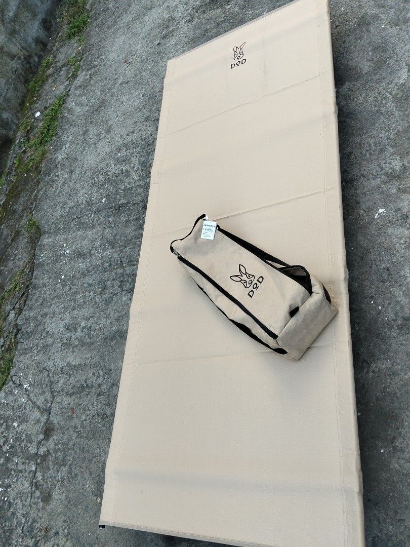 DOD Camping Cot Tan Color Portable Bed (Category: Hiking & Camping) located in Abucay. Submitted by cristineca20489 (Listing ID 1470334100, Image 2). Description: - Brand: DOD Camping Cot - Color: Stylish Tan - Weight: Lightweight at only 2.6kg - Capacity: Sturdy build supports up to 120kg - Setup: Fast and easy assembly with black metal legs and poles - Portability: Packs down compactly into the included carry bag - Versatility: Ideal for outdoo