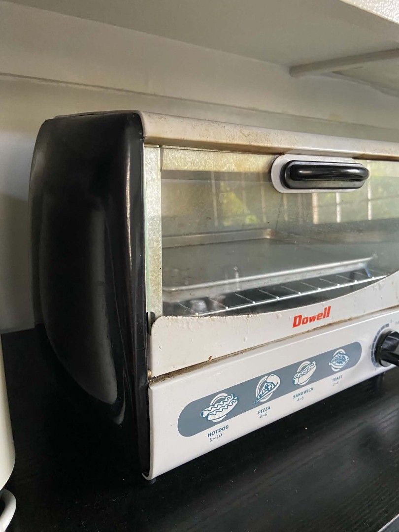 Dowell Mini Toaster Oven with Baking Tray (Category: Ovens & Toasters) located in Quezon City. Submitted by rapstoreph (Listing ID 1470256900, Image 3). Description: - Brand: Dowell toaster oven in stylish white and black - Size: Compact design, ideal for small kitchens, condos, or dorm rooms - Features: 15-minute timer knob and printed cooking guides for hotdog, pizza, sandwich, and toast - Inclusion: Comes with a matching baking tray - Conditio