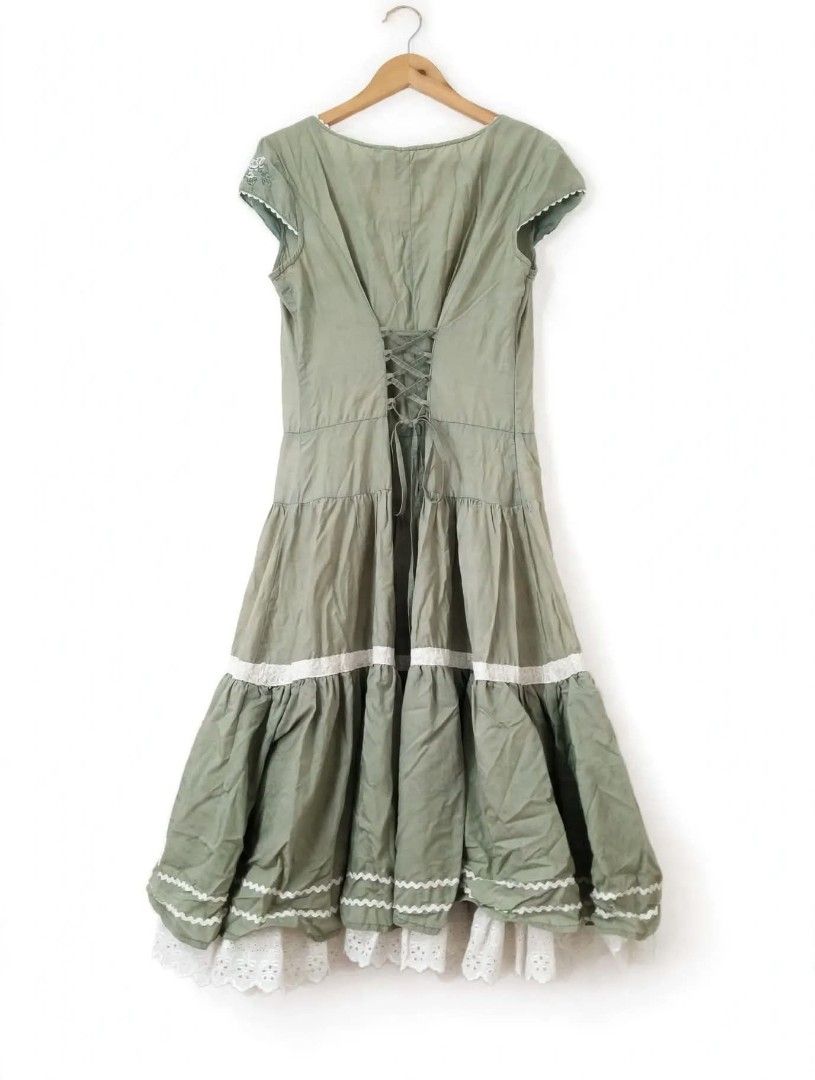 Dress with eyelet lace (Category: Dresses) located in Bacoor. Submitted by leah.92 (Listing ID 1470278911, Image 2). Description: *Details:* - Color: Sage Green / Light Olive - Style: Cottagecore / Prairie / Boho Milkmaid Dress - Neckline: V-neck with white ricrac trim - Front: Floral embroidered panel with functional buttons (6 buttons) - Sleeves: Short cap sleeves - Skirt: Tiered ruffle with white lace band + double white ricrac + eyelet lace u