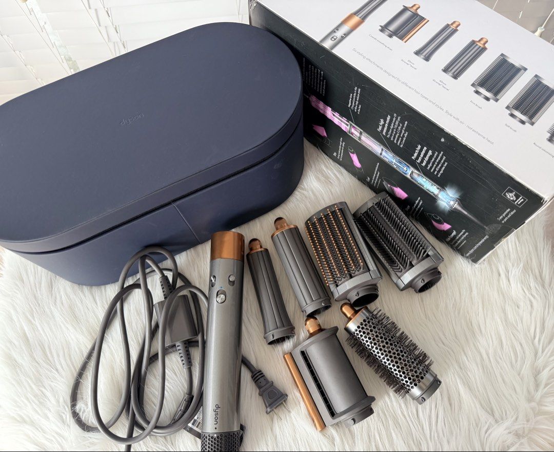 Dyson Airwrap Multi-Styler Complete (Category: Hair) located in Cainta. Submitted by mskath__ (Listing ID 1470223590, Image 1). Description: - Authentic Dyson Airwrap multi-styler set (Nickel/Copper) - Condition: Excellent, complete set with original box and presentation case - Includes 6 attachments: Coanda smoothing dryer, 30mm & 40mm barrels, firm & soft smoothing brushes, and round volumising brush - Prevents extreme heat damage while styling