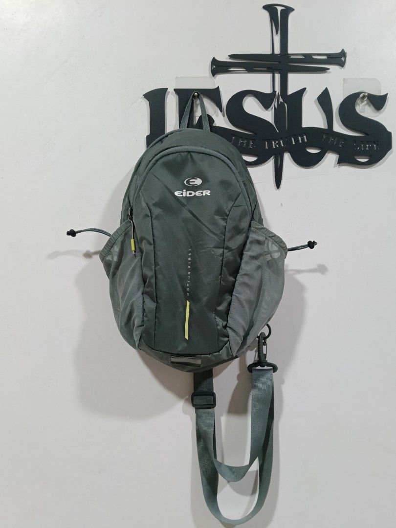 Eider Motion First Sling Backpack Gray (Category: Backpacks) located in Manila. Submitted by tristan12_13 (Listing ID 1470312789, Image 1). Description: - Brand: Eider Motion First - Color: Gray - Strap: Single padded mesh strap with adjustable buckle and D-ring clip - Back Panel: Breathable mesh with vertical YKK zippered pocket - Storage: Two side mesh pockets with adjustable bungee cord closures - Design: Large Eider logo printed on the front 