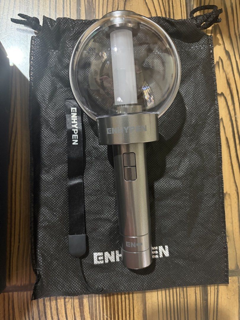 ENHYPEN Official Lightstick with Photocards (Category: K-Wave Merchandise) located in Batangas. Submitted by mailsbypearl (Listing ID 1470161920, Image 3). Description: - Official ENHYPEN lightstick, tested and 100% working - Complete inclusions: original box with serial number sticker, black dust bag, and wrist strap - Includes 4 official member photocards: Jungwon, Ni-ki, Sunghoon, and Jay - Condition: Lightstick is excellent, box has minor edg