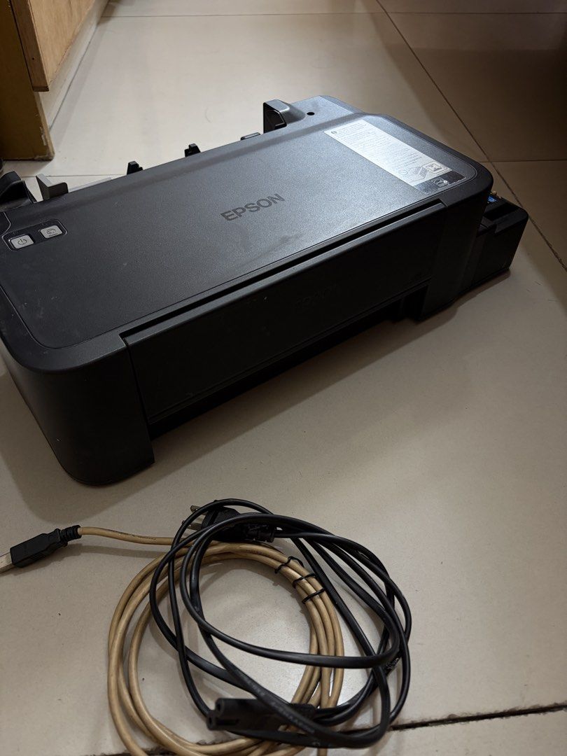 Epson L121 EcoTank Printer with Ink Bottles and Cables (Category: Printers, Scanners & Copiers) located in Manila. Submitted by piafreebee_316 (Listing ID 1470206830, Image 2). Description: Epson L121 Printer FOR SALE - well-used; gumagana pa siya but kinakain nya yung paper. kayo nalang po magpa-ayos - full inks pa, kakarefill lang; with inks authentic ink included - black, cyan, yellow, magenta (bought in national bookstore) - damage rear paper