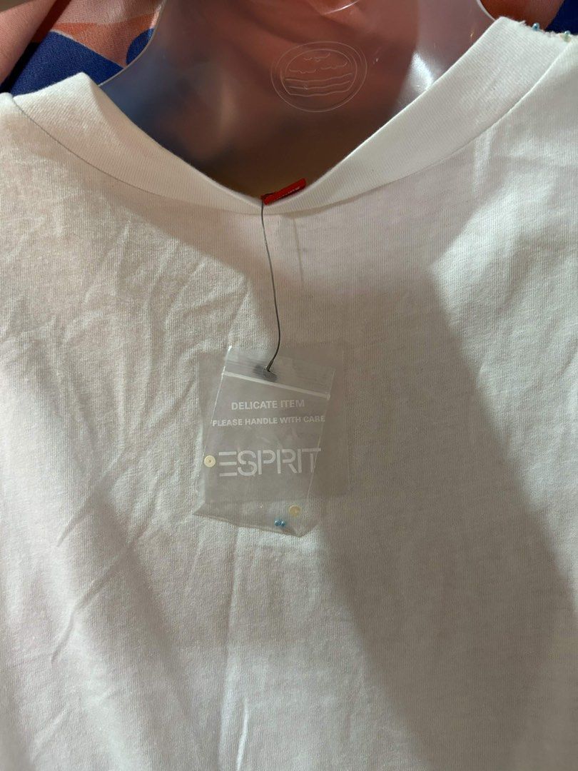 Esprit White Beaded V-Neck Sleeveless Top (Category: Sleeveless) located in Manila. Submitted by lovely.453 (Listing ID 1470267797, Image 2). Description: Esprit white sleeveless top with deep V-neck and beaded detailing. Empire waist cut with self-tie straps at the back. Delicate beadwork along the neckline and front diamond patch. Red brand tag at the collar. Spare beads pouch still attached to the label. Lightweight cotton fabric..