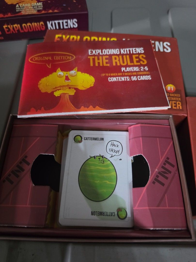 Exploding Kittens Card Game (2 pcs available) (Category: Board Games & Puzzles) located in Manila. Submitted by kimmmiii999 (Listing ID 1470146671, Image 2). Description: Exploding kittens. Used. See pics..