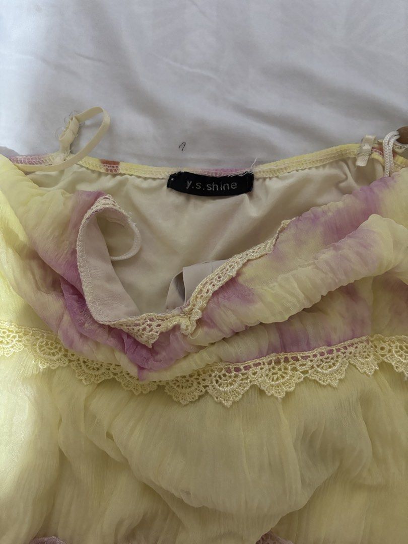 Fairycore Lace-Trim Cami Top (Category: Sleeveless) located in Bulacan. Submitted by shandeclutterx (Listing ID 1470218900, Image 3). Description: Dreamy pastel yellow and pink flowy cami with lace details, dainty beaded straps, and the cutest ruffled hem! Super girly & giving 2000s fairy vibes. 2nd slide is a real when worn. Passed down to me by my mom! 💗 Such a unique, dreamy piece with the prettiest lace details and flowy silhouette. The stra