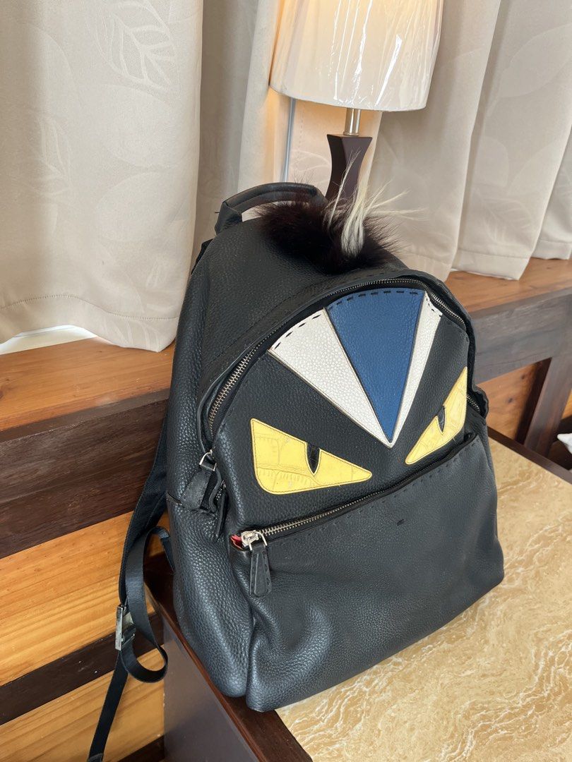 Fendi Monster Backpack Black Leather (Category: Backpacks) located in Tacloban City. Submitted by luxbag_phhh (Listing ID 1470158512, Image 2). Description: Fendi Monster Eyes leather backpack in black. Features striking blue and white triangular accents, a luxurious fur top detail, comfortable mesh-padded straps, and a secure front zipper pocket. Inside, you'll find the Fendi Selleria silver-tone serial number plaque. A stylish and rare statemen
