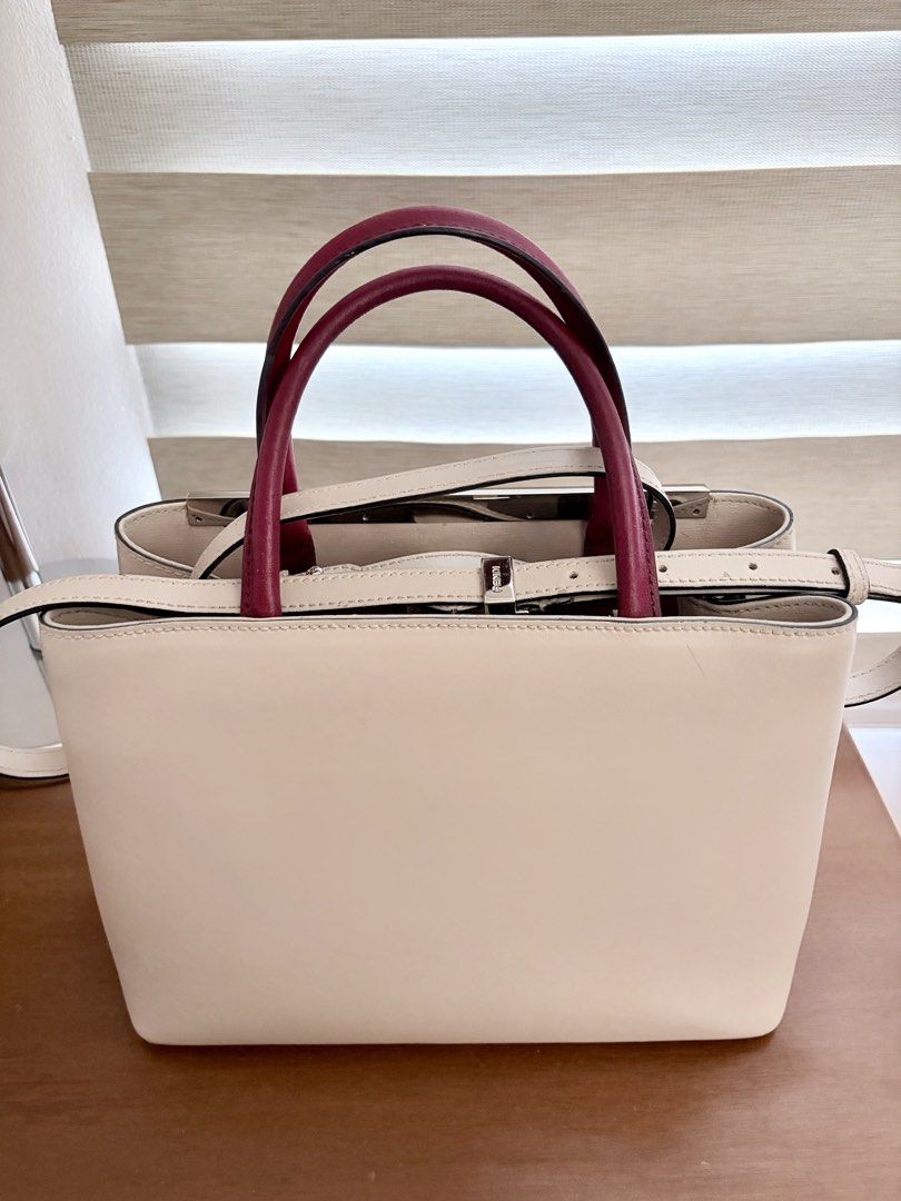 Fendi Monster Bag (Category: Luxury Bags & Wallets) located in Quezon City. Submitted by miniscloset (Listing ID 1470217475, Image 3). Description: - Brand: Fendi - Style: Structured handbag/crossbody - Colorway: Off-white, pink, and burgundy leather - Hardware: Silver-tone with top metal bar and hanging charm - Carry options: Dual top handles and attached shoulder strap - Interior: Multiple compartments divided by a rigid partition - Color enhan