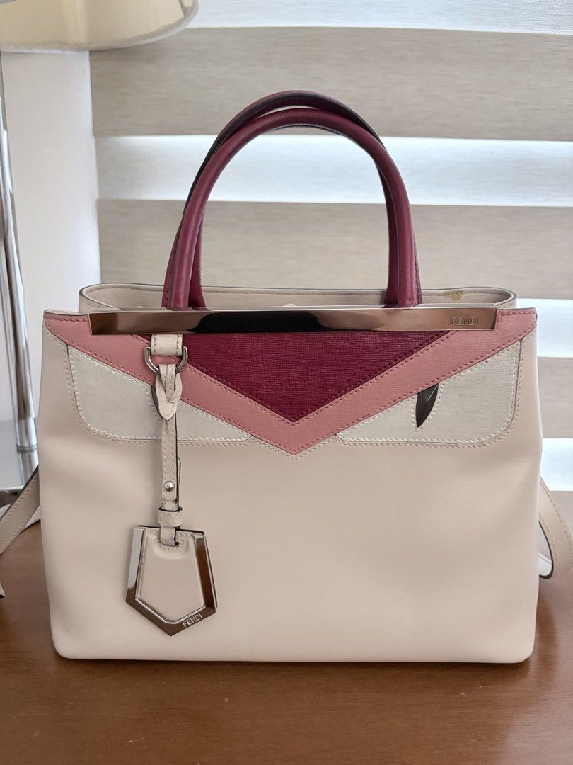 Fendi Monster Bag (Category: Luxury Bags & Wallets) located in Quezon City. Submitted by miniscloset (Listing ID 1470217475, Image 1). Description: - Brand: Fendi - Style: Structured handbag/crossbody - Colorway: Off-white, pink, and burgundy leather - Hardware: Silver-tone with top metal bar and hanging charm - Carry options: Dual top handles and attached shoulder strap - Interior: Multiple compartments divided by a rigid partition - Color enhan