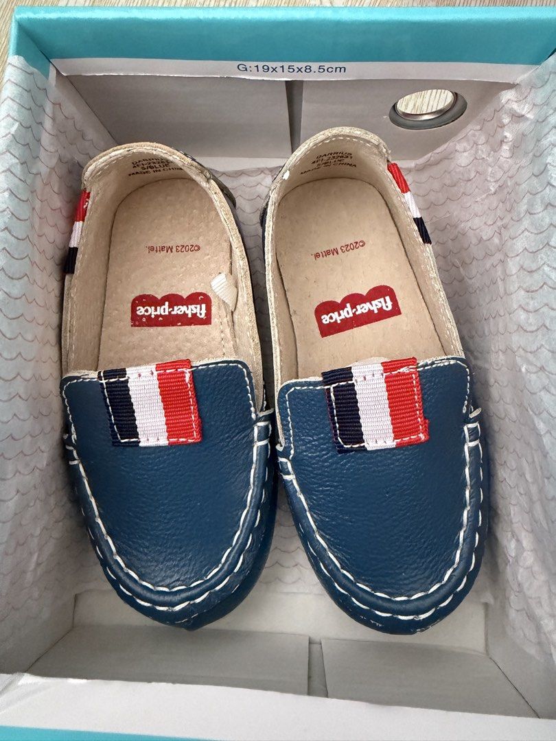 Fisher-Price Darrius Blue Loafers (Category: Babies & Kids Fashion) located in Naga. Submitted by suit_yourslf (Listing ID 1470150528, Image 1). Description: - Brand: Fisher-Price (Darrius style) - Color: Blue with red, white, and blue stripe details - Size: Toddler Size 5 - Design: Easy slip-on loafers with white contrast stitching - Inclusions: Original box included - Condition: Great for casual wear or special occasions.