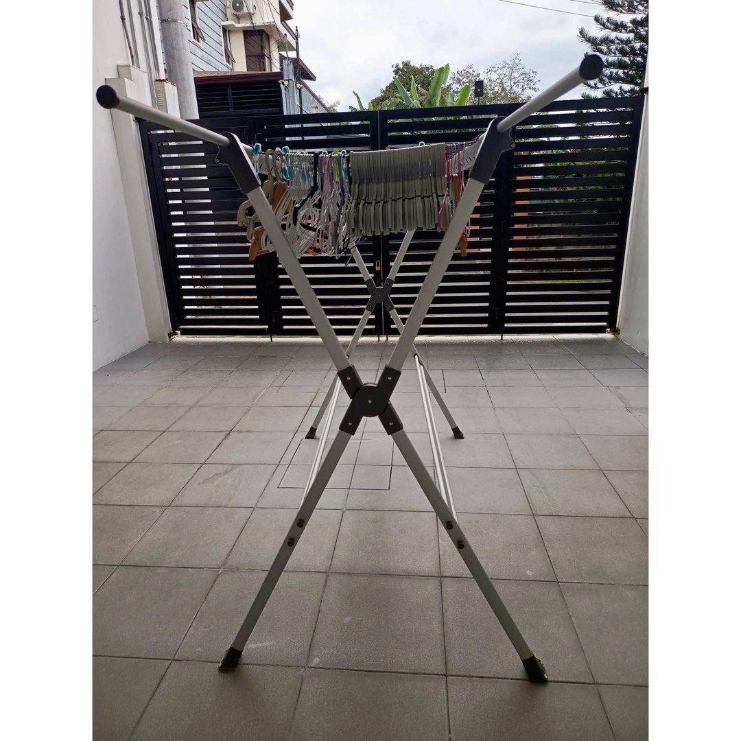 Foldable Aluminum Clothes Drying Rack / Laundry Hanger Stand (Category: Clothes Drying Rack) located in Rizal. Submitted by mariasdeclutteringshop (Listing ID 1470293948, Image 3). Description: Features: * Sturdy metal/aluminum-style frame * Multiple hanging bars for clothes and hangers * Foldable design for easy storage * Space-saving and practical for home laundry * Suitable for indoor or outdoor use * Comes with side arms for additional hangin
