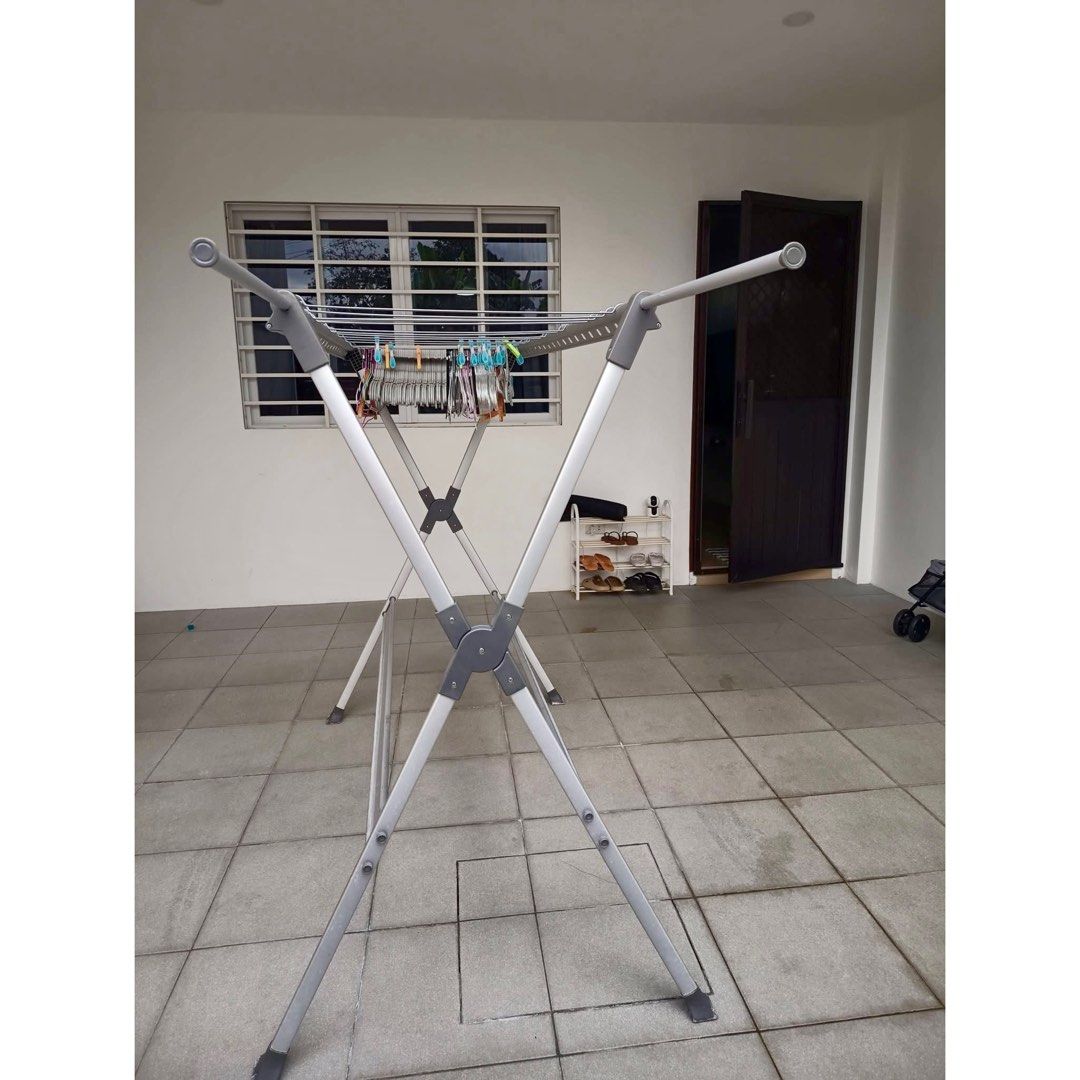Foldable Aluminum Clothes Drying Rack / Laundry Hanger Stand (Category: Clothes Drying Rack) located in Rizal. Submitted by mariasdeclutteringshop (Listing ID 1470293948, Image 2). Description: Features: * Sturdy metal/aluminum-style frame * Multiple hanging bars for clothes and hangers * Foldable design for easy storage * Space-saving and practical for home laundry * Suitable for indoor or outdoor use * Comes with side arms for additional hangin