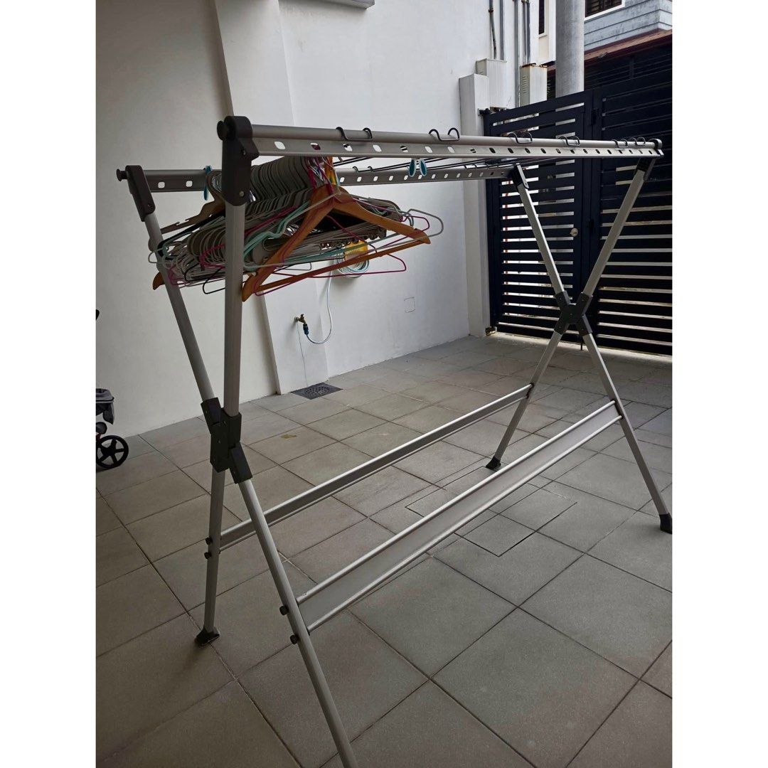 Foldable Aluminum Clothes Drying Rack / Laundry Hanger Stand (Category: Clothes Drying Rack) located in Rizal. Submitted by mariasdeclutteringshop (Listing ID 1470293948, Image 1). Description: Features: * Sturdy metal/aluminum-style frame * Multiple hanging bars for clothes and hangers * Foldable design for easy storage * Space-saving and practical for home laundry * Suitable for indoor or outdoor use * Comes with side arms for additional hangin