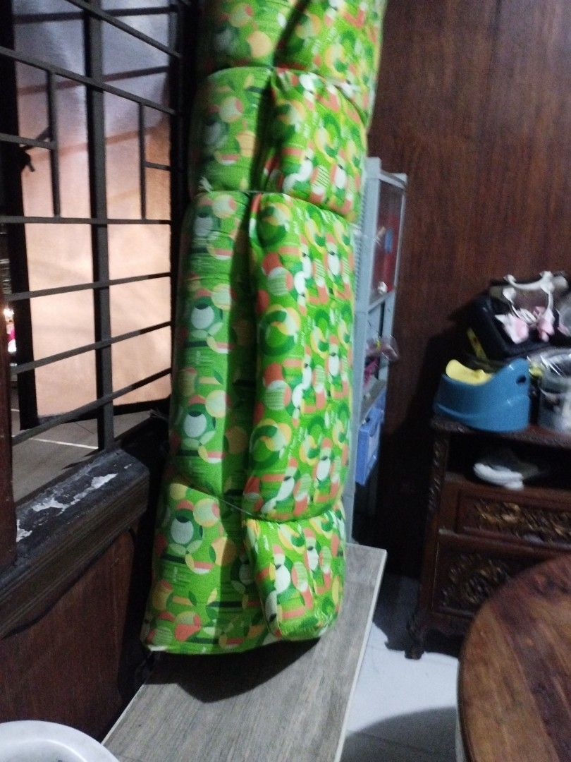 Foldable Mattress Green Pattern (Category: Bed Frames & Mattresses) located in Manila. Submitted by deguzmandh17516 (Listing ID 1470254420, Image 1). Description: - Color & Design: Green with a stylish circular geometric pattern - Material: Thick, comfortable foam construction - Space-Saving: Easily folds up for compact storage - Versatile Use: Ideal as a spare mattress for guests or for floor sleeping - Condition: Clean fabric cover, tied up nea