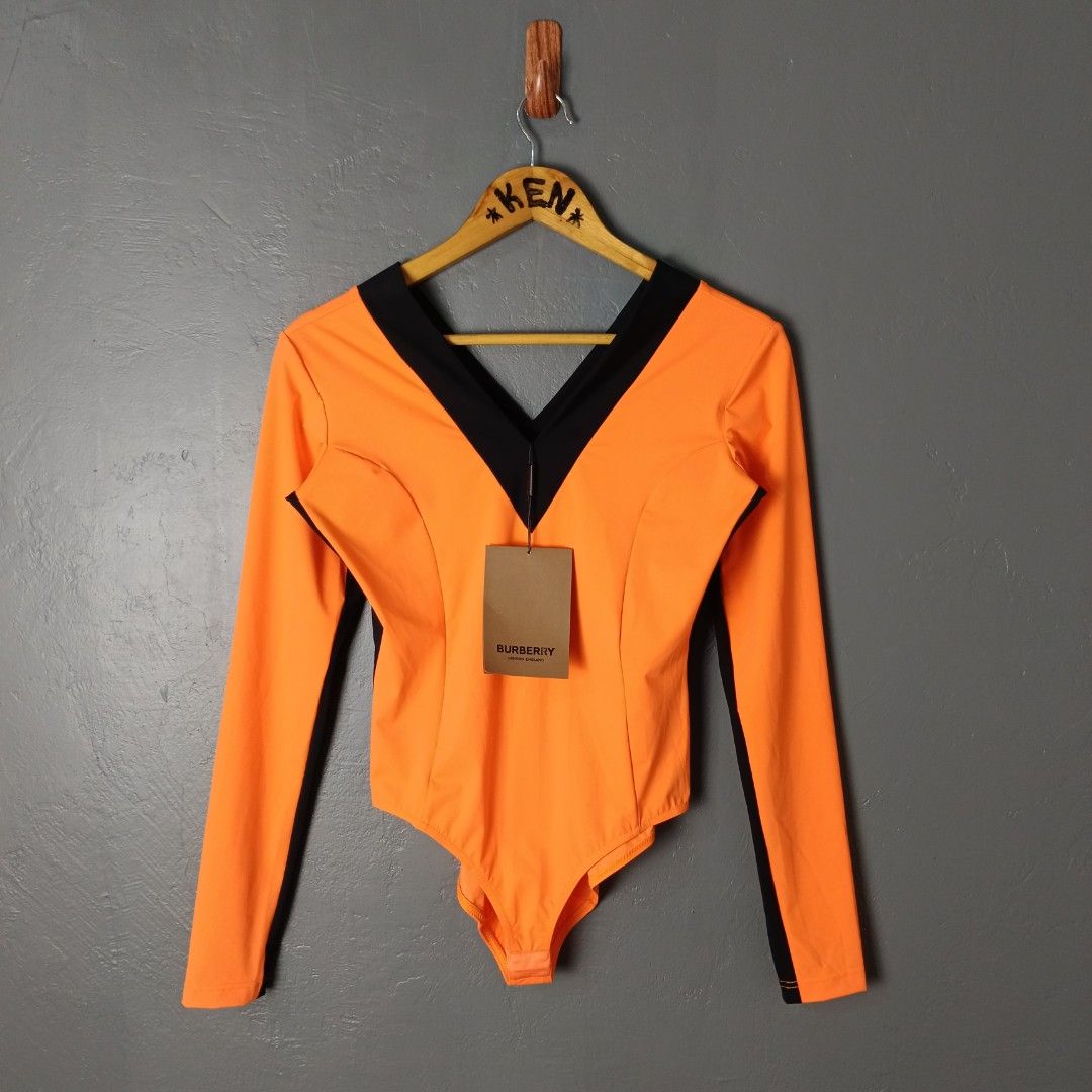 For Women - Burberry - Bodysuit (Category: Others Tops) located in Bacolod City. Submitted by drop.ph (Listing ID 1470160150, Image 1). Description: Burberry - Bright Orange Body Suit *Stretchable *Size M - 16.5x17.5 *Brand New w Tags *Minor ink stain at the back *Price: 1,800php *Add SF if outside Bacolod City.