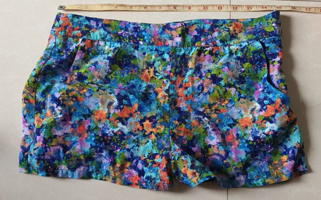 Forever 21 Floral Print Shorts Size M (Category: Shorts) located in Meycauayan. Submitted by shoptoown (Listing ID 1470177654, Image 2). Description: - Brand: Forever 21 - Size: M (Made in Vietnam) - Design: Vibrant floral print (Blue, Green, Orange, Purple) with solid blue lining - Measurements: Waist ~15 inches across, Length ~13 inches - Condition/Features: Comfortable casual fit, lightweight and perfect for warm weather.