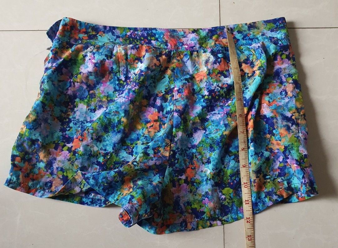 Forever 21 Floral Print Shorts Size M (Category: Shorts) located in Meycauayan. Submitted by shoptoown (Listing ID 1470177654, Image 3). Description: - Brand: Forever 21 - Size: M (Made in Vietnam) - Design: Vibrant floral print (Blue, Green, Orange, Purple) with solid blue lining - Measurements: Waist ~15 inches across, Length ~13 inches - Condition/Features: Comfortable casual fit, lightweight and perfect for warm weather.