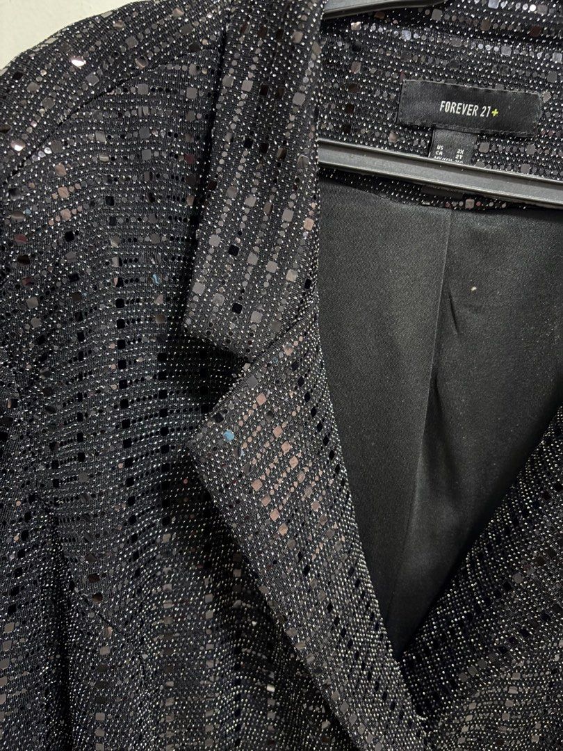 Forever 21 Plus Black Sequin Blazer Jacket Size 2X (Category: Coats, Jackets and Outerwear) located in Pateros City. Submitted by selleysells (Listing ID 1470242906, Image 2). Description: - Brand: Forever 21 Plus - Size: 2X - Color: Black with sparkling sequin fabric - Design: Structured lapels and front button closure - Comfort: Fully lined interior - Style Tip: Great statement piece for parties, nights out, or dressing up casual looks.