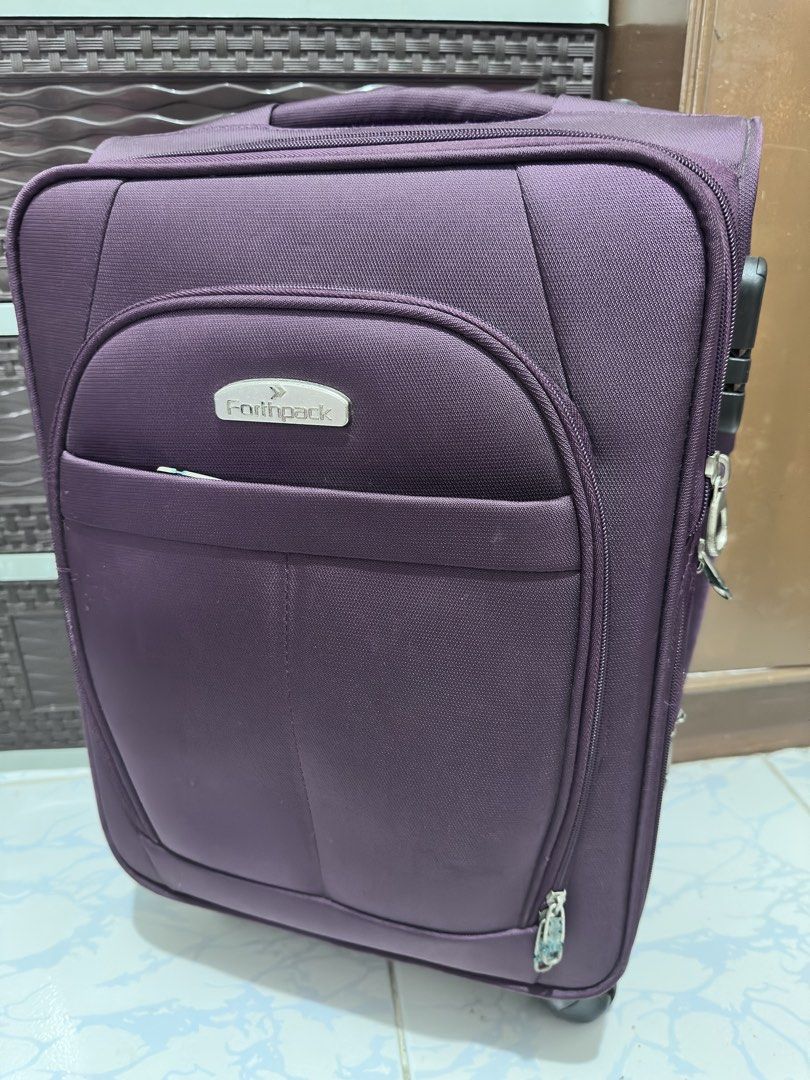 Forthpack Purple Luggage Suitcase Rolling Bag (Category: Luggage) located in Malolos. Submitted by sam.sam10 (Listing ID 1470218162, Image 1). Description: - Brand: Forthpack - Color: Purple - Features: Smooth-rolling wheels, retractable handle, and built-in side combination lock - Storage: Multiple secure zipper compartments and convenient front pockets - Handles: Top and side carry handles for easy lifting - Condition: Good working condition wi