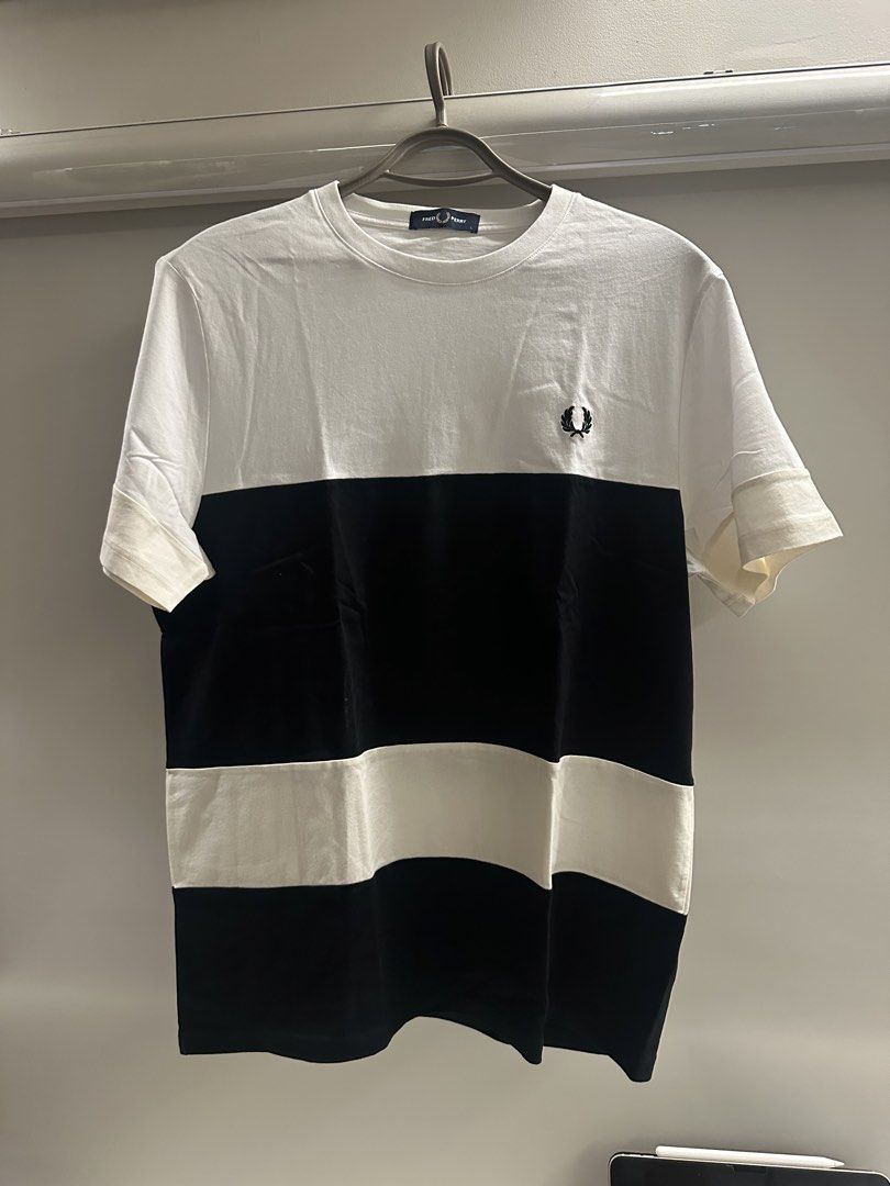 Fred Perry Colorblock T-Shirt Size L (Category: Tshirts & Polo Shirts ) located in Quezon City. Submitted by adc2011 (Listing ID 1470229077, Image 1). Description: - Brand/Model: Fred Perry Graphic Tee - Color: White and black with horizontal striped panel - Details: Crew neck, short sleeves, embroidered laurel wreath logo on chest, 'Original Since 1952' print near lower back hem - Size: Large (tag attached) - Condition: Clean fabric, no stains o