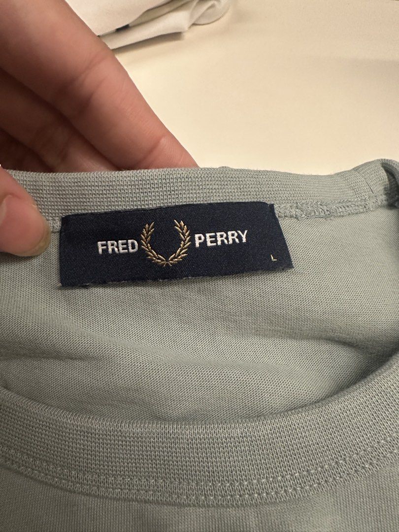 Fred Perry Green T-Shirt Size L (Category: Tshirts & Polo Shirts ) located in Quezon City. Submitted by adc2011 (Listing ID 1470229053, Image 3). Description: - Brand: Fred Perry - Item: Crewneck T-Shirt - Color: Muted light green with bronze embroidered laurel wreath logo - Size: Large - Details: Short sleeves, ribbed collar - Condition: Clean, excellent, ready to wear - Style: Classic casual streetwear basic.
