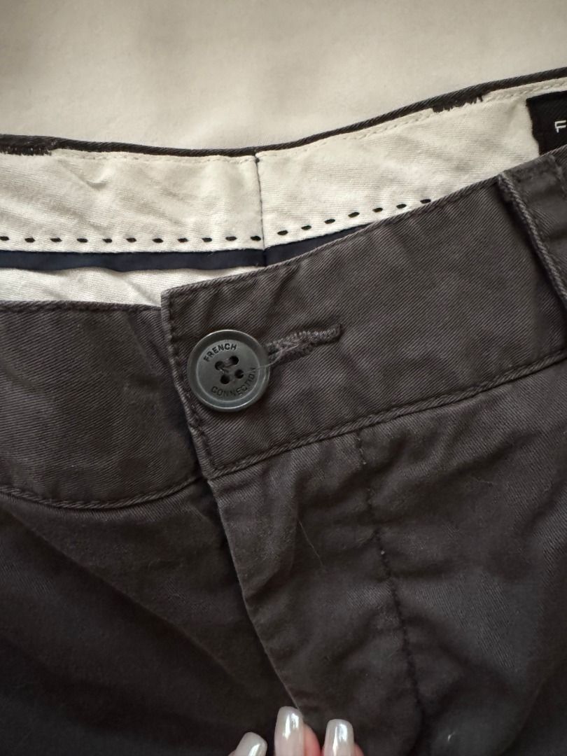 French Connection Grey Chinos Size 30 (Category: Chinos) located in Cebu City. Submitted by _t.rix (Listing ID 1470164224, Image 2). Description: - Brand: French Connection - Size: 30 - Colour: Dark Grey (Solid neutral) - Fit: Straight leg silhouette - Closure: Standard button fly - Pockets: Front slant pockets and back welt pockets with button flap detailing - Details: Clean interior lining with printed branding on the waistband - Condition: Gre