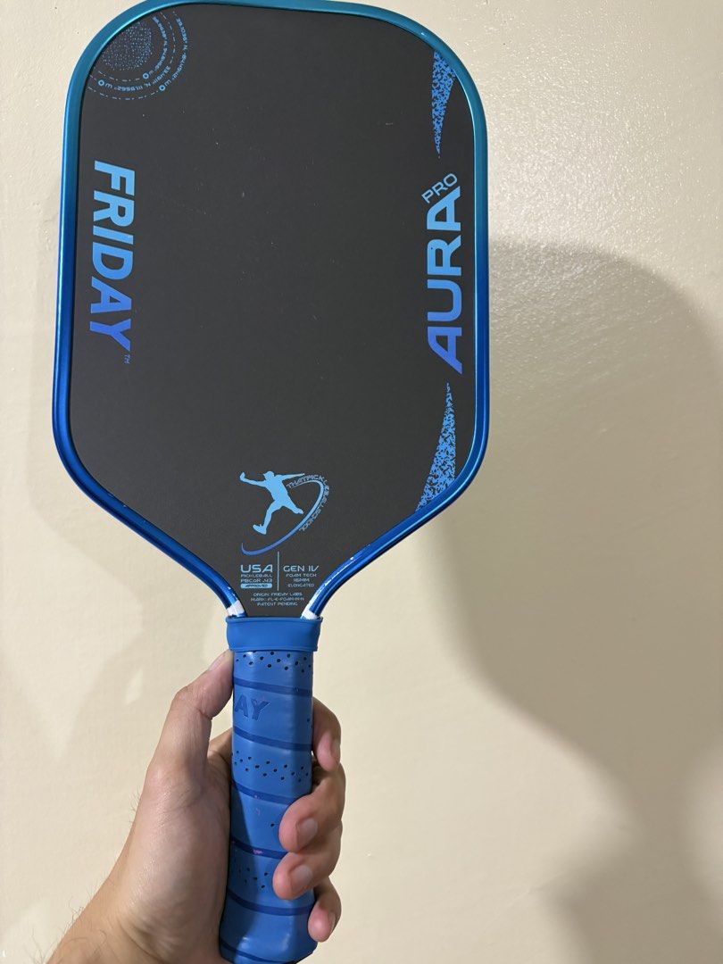 Friday Aura Pro Metallic Cobalt (Category: Racket and Ball Sports) located in Manila. Submitted by juanmarcos01 (Listing ID 1470263413, Image 3). Description: Limited Edition Friday Aura Pro Metallic Cobalt created in collaboration with Kyle Koszuta, better known as ThatPickleballGuy. Friday Aura Pro Gen IV pickleball paddle. 16mm thickness elongated shape Original blue grip tape, USA Pickleball approved. Includes matching zippered protective cov