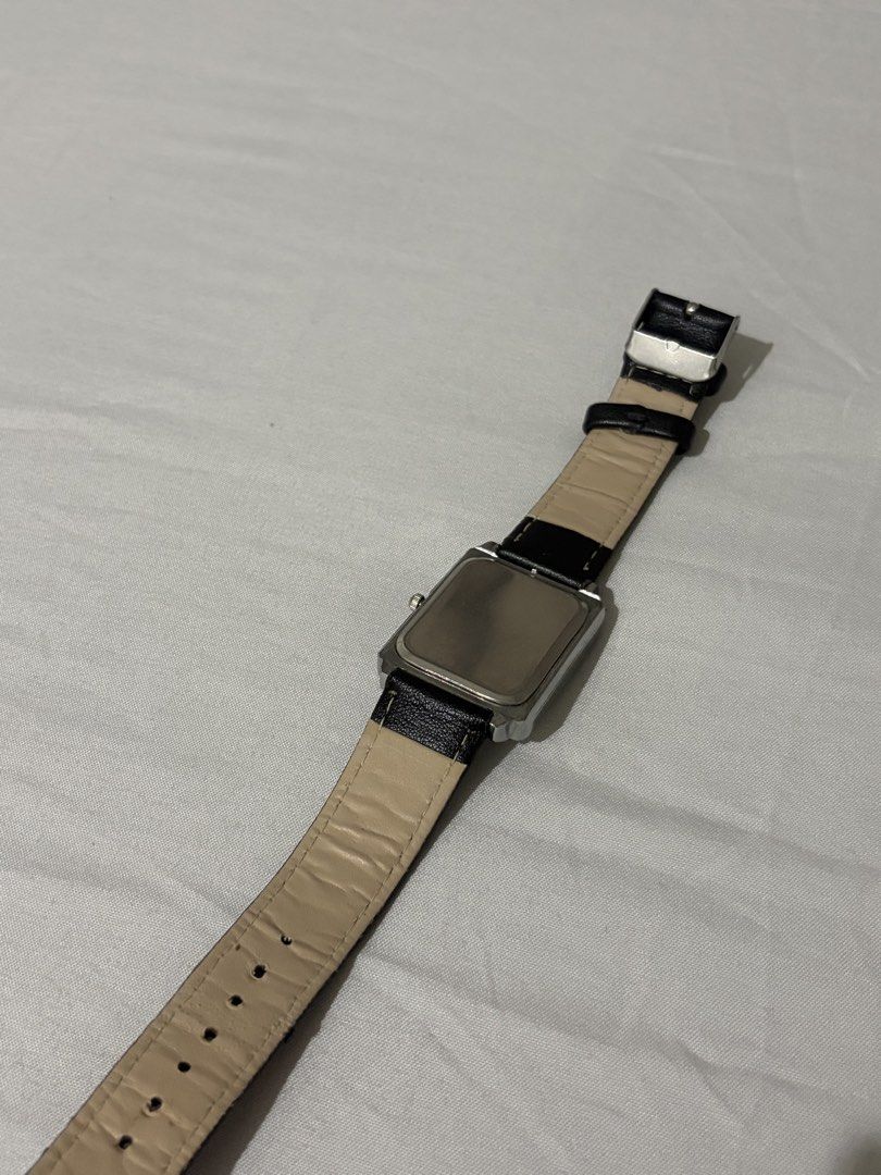 Geduo rectangular quartz watch with black leather strap (Category: Women's Watches) located in Quezon City. Submitted by clareb (Listing ID 1470286004, Image 2). Description: - Brand/Model: Geduo Quartz Dress Watch - Case: Rectangular silver case - Dial: White dial with classic black Roman numerals and striking blue hands - Strap: Black faux leather with beige backing and standard buckle closure - Style: Classic, lightweight, and versatile for ev
