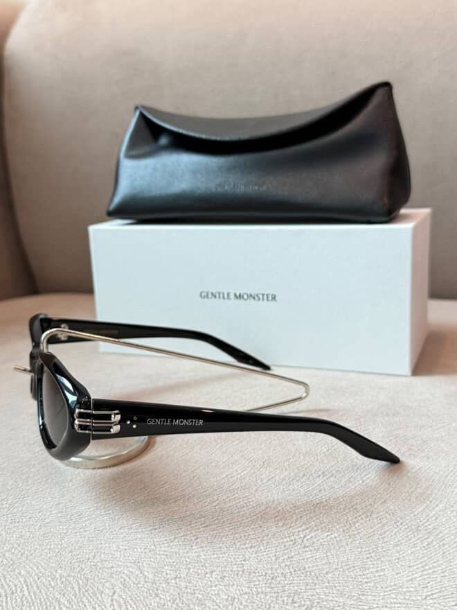 Gentle Monster Sunglasses Black with Case (Category: Sunglasses & Eyewear) located in Caloocan City. Submitted by izzie_finds (Listing ID 1470189636, Image 3). Description: - Brand: Gentle Monster - Color: Black with unique metal bridge detail and temple branding - Condition: Brand new, unworn, pristine shape - Lenses: Clear with zero scratches - Inclusions: Original white box and black leatherette case.