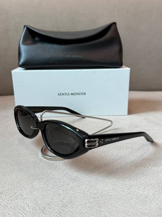 Gentle Monster Sunglasses Black with Case (Category: Sunglasses & Eyewear) located in Caloocan City. Submitted by izzie_finds (Listing ID 1470189636, Image 1). Description: - Brand: Gentle Monster - Color: Black with unique metal bridge detail and temple branding - Condition: Brand new, unworn, pristine shape - Lenses: Clear with zero scratches - Inclusions: Original white box and black leatherette case.